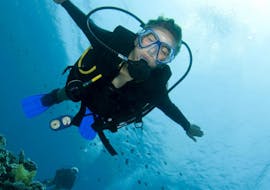 A participant dives underwater with her scuba gear at the PADI Discover Scuba Dive around Pserimos with Liamis Dive Center Kos.