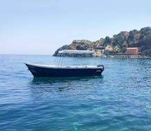 Una de las dos embarcaciones de Navigando per Trezza en el mar durante el viaje en barco por la Riviera de los Cíclopes.
