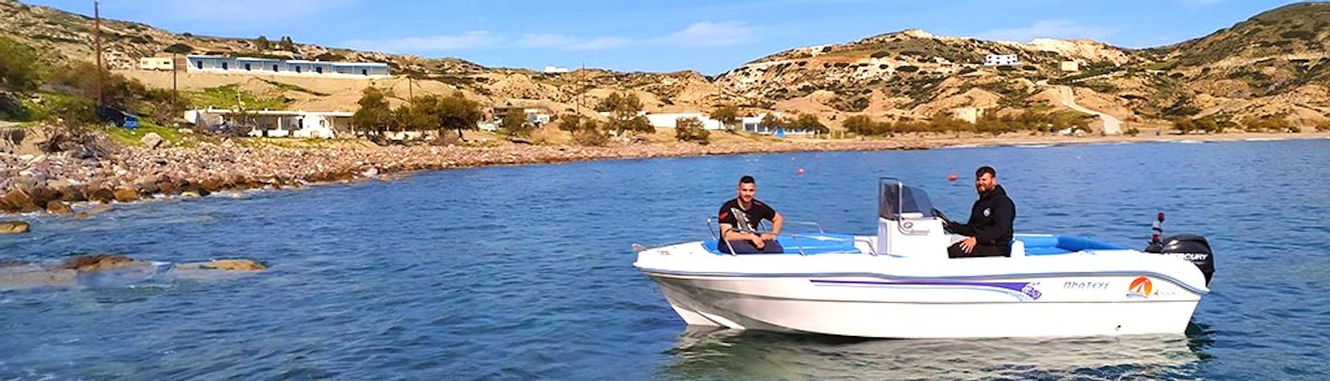 Two men enjoying the boat rental in Agia Kiriaki (up to 6 people) with Indigo Yacht Milos.