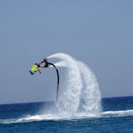 A man practices flyboarding at Psalidi beach with Flyboard Watersports Kos.