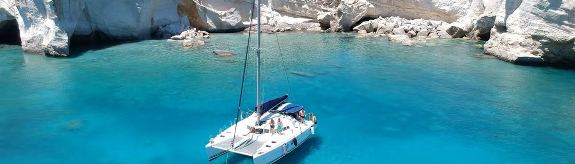 Picture of the catamaran in cristal-clear waters in the catamaran trip around Milos & Poliegos with Lunch with Polco Sailing.