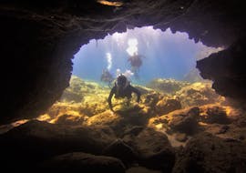 Divers dive into a cave and discover marine life on the PADI Advanced Open Water Diver course in Penera for certified divers with Taba Diving Cyprus.