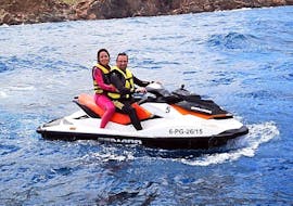 Two friends riding a jet ski during a Jet Ski Safari from l'Estartit to Medes Islands with Lassdive.