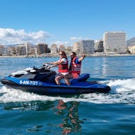 A couple riding a jet ski during a Jet Ski in Fuengirola along the Coast with Fuengirolanautic.