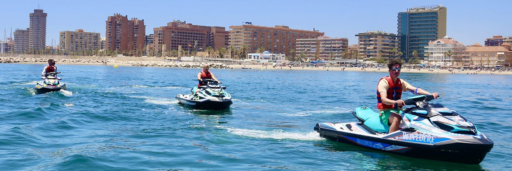 A group of friends practising Jet Ski in Fuengirola along the Coast with Fuengirolanautic.