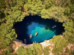 Bird's-eye view of the breathtaking Melissani Cave, visited in the private boat trip from Zakynthos to Kefalonia with snorkeling with Serene Private Cruises.
