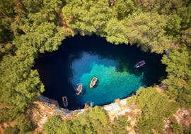 Bird's-eye view of the breathtaking Melissani Cave, visited in the private boat trip from Zakynthos to Kefalonia with snorkeling with Serene Private Cruises.
