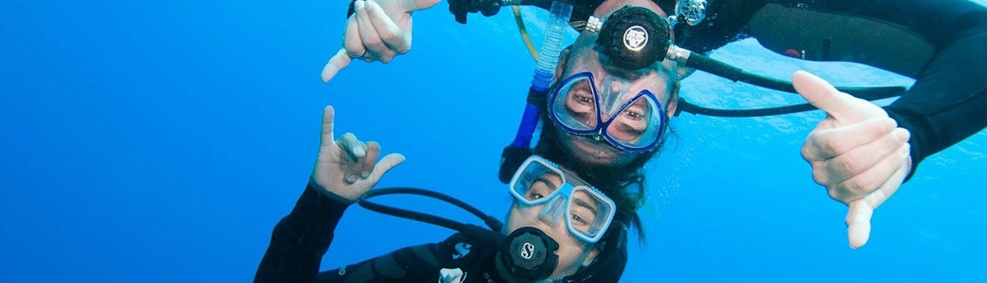 Una ragazza e un nostro istruttore si divertono durante l'ultima immersione del corso Immersioni di prova (PADI) a Capoliveri per principianti con Mandel Diving Center.