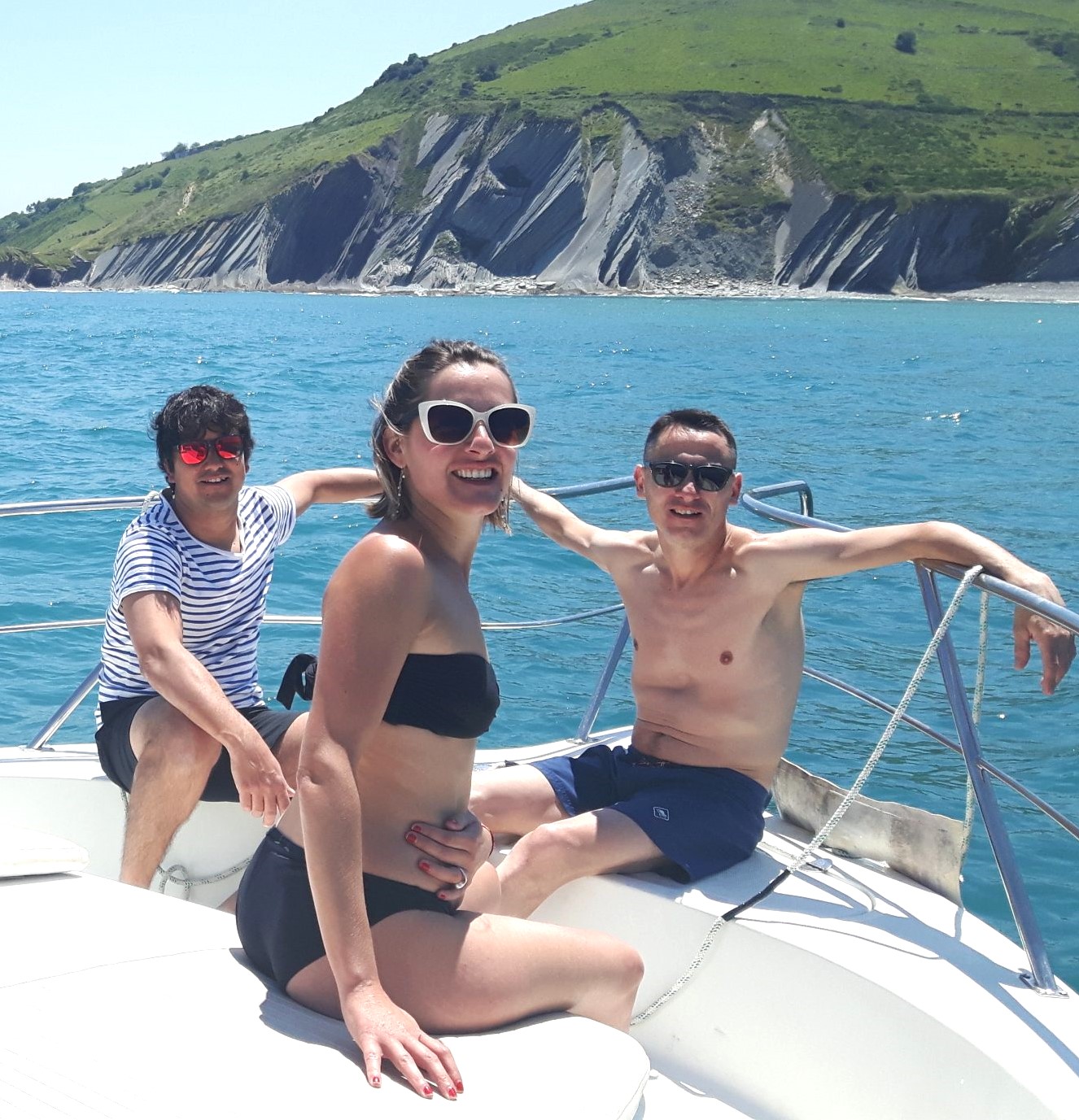 People sunbathing during a Private Yacht Trip around San Sebastian Coast with Getari Charter.