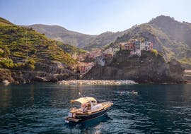 The boat of San Giorgio Boats navigating towards one of the village of Cinque Terre during a private Boat Trip to Porto Venere & Cinque Terre with Lunch.