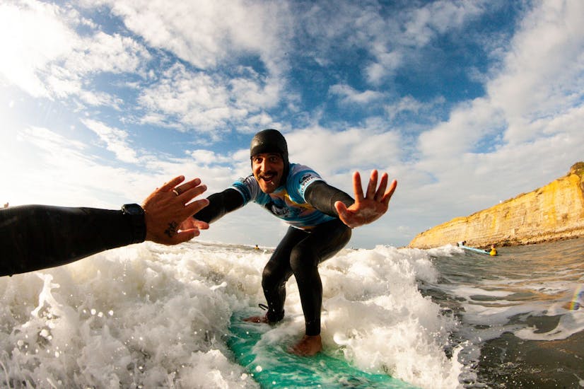 Two people having fun during their Private Surf Lessons (from 7 y.) for Intermediates in Ericeira with Surf365 Ericeira.