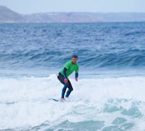 A person surfing during the Private Surf Lessons (from 6 y.) in Nazaré with Zulla Surf School Nazaré.
