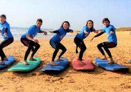 A group of people with surfboards on the beach during the Surf Lessons (from 8 y.) on Praia da Galé in Albufeira with Surf4Fun Albufeira.