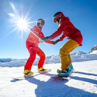 Uno snowboarder impara a trovare l'equilibrio durante una lezione privata di snowboard per bambini e adulti di tutti i livelli con ESF Chamonix.