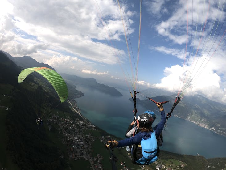 A paraglider above the lake at Tandem Paragliding from the Niederbauen - Thermic with SkyGlide Emmetten-Lucerne.