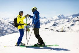 The ski instructor and a student give each other a high five before rocking the slopes at the private ski lessons for adults of all levels with the Bergsport JA Oberstdorf ski school.
