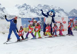 Kids posing in front of the camera with their ski instructor during the Kids Ski Lessons (3-12 y.) for Beginners with Scuola Italiana Sci Marilleva.
