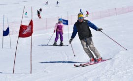 An adult is skiing on a slope during the Adult Ski Lessons (from 13 y.) for All Levels with Scuola Italiana Sci Marilleva.