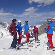 Adults standing in the row on the slope during the Adult Ski Lessons for All Levels with Prime Mountain Sports Engelberg.