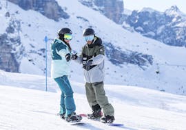 An instructor and a snowboarder during the Private Snowboarding Lessons for All Levels with Scuola di Snowboard Zebra Madonna di Campiglio.