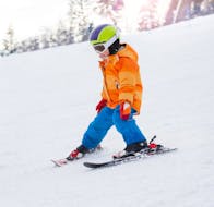 Picture of a kid doing a descent during the Kids Ski Lessons (6-15 y.) for Beginners with Promescaiol Ski & Snow Academy Daolasa.