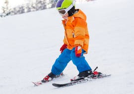 Picture of a kid doing a descent during the Kids Ski Lessons (6-15 y.) for Beginners with Promescaiol Ski & Snow Academy Daolasa.