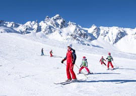 Kinderen skiën met hun instructeur tijdens de Kids Ski Lessen "Max 7" (4-12 j.) bij ESF La Tania.