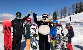 Kids have fun during the Kids & Adult Snowboarding Lessons (from 4 y.) for Advanced Boarders with Skischule Grächen - Zenklusen Sport.