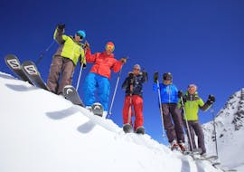 Skiers are standing on a snowy ridge during their Adult Ski Lessons (from 14 y.) - Max 8 per group with Prosneige Val Thorens & Les Menuires.