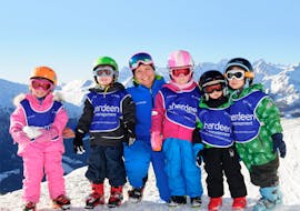 A group of skiers at the kids ski lessons "Polar Bears" (3-5 yrs) for all levels with the Altitude Ski School Zermatt take a final photo after a successful kids' ski lessons in Zermatt.