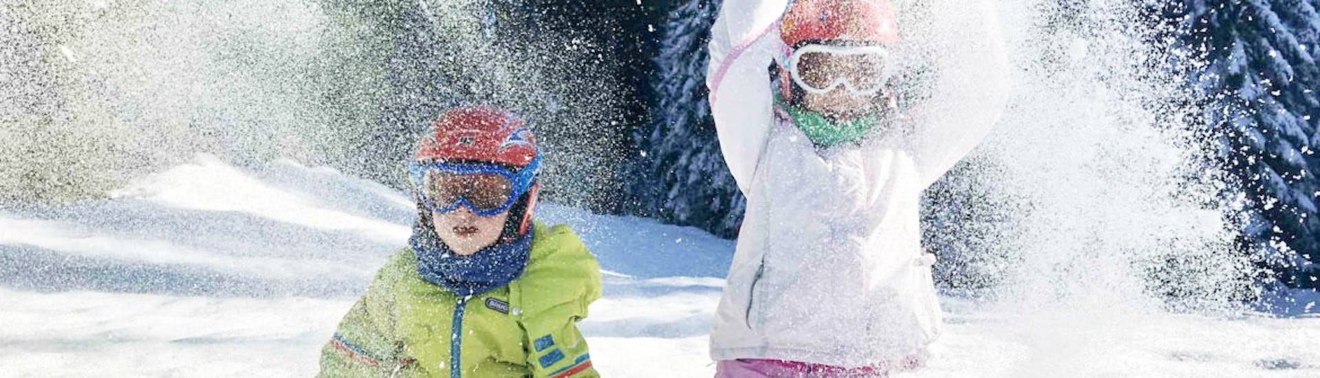 Two kids playing during the Kids Ski Lessons (5-12 y.)  for Experienced Skiers with Scuola Sci Scie di Passione Folgaria.