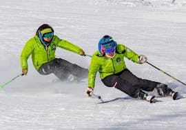 Two instructors from Scuola Sci Palafavera - Val di Zoldo during the Private Ski Lessons for Adults of All Levels.
