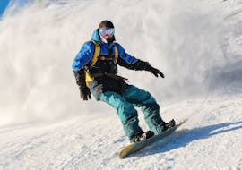 A participant is riding on a slope during the Private Snowboarding Lessons for Kids & Adults of All Levels with Scuola Sci Palafavera - Val di Zoldo.