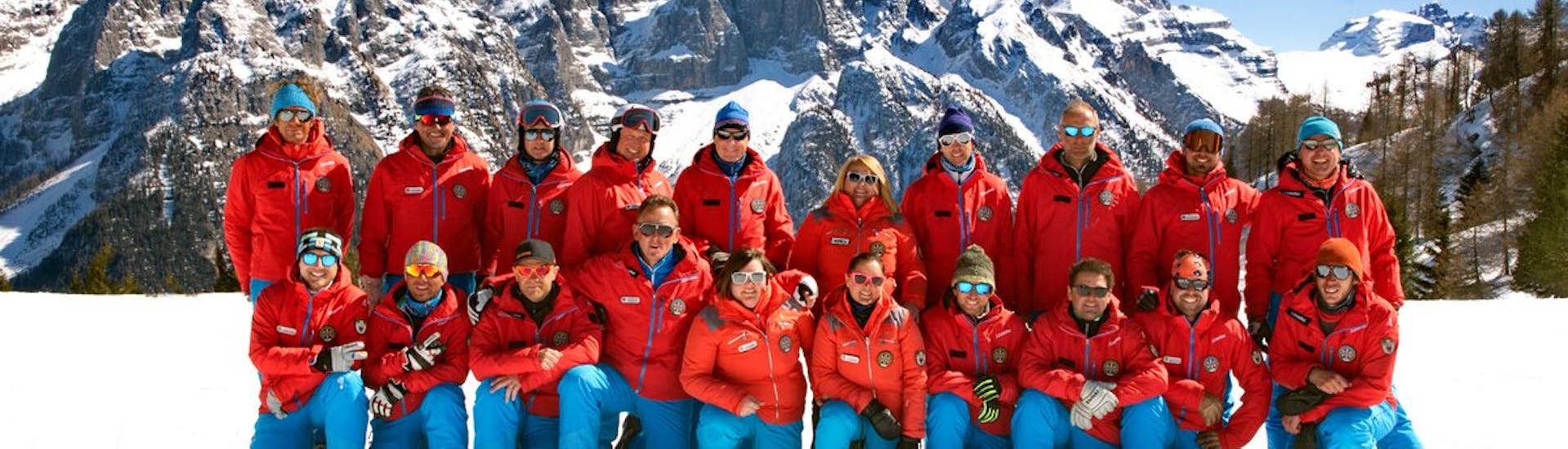 The ski and snowboard instructors from Scuola di Sci Val di Sole are posing in front of the camera.