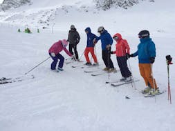 A group of adults learns the correct posture at the adult ski lessons for skiers with experience with Ski-fun.
