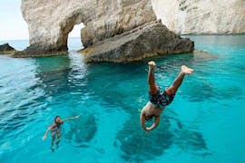 Two people swimming in the sea close to the Blue Caves during the 1 Day Boat & Bus Trip from Zakynthos to Shipwreck Beach and the Blue Caves with Abba Tours Zante.