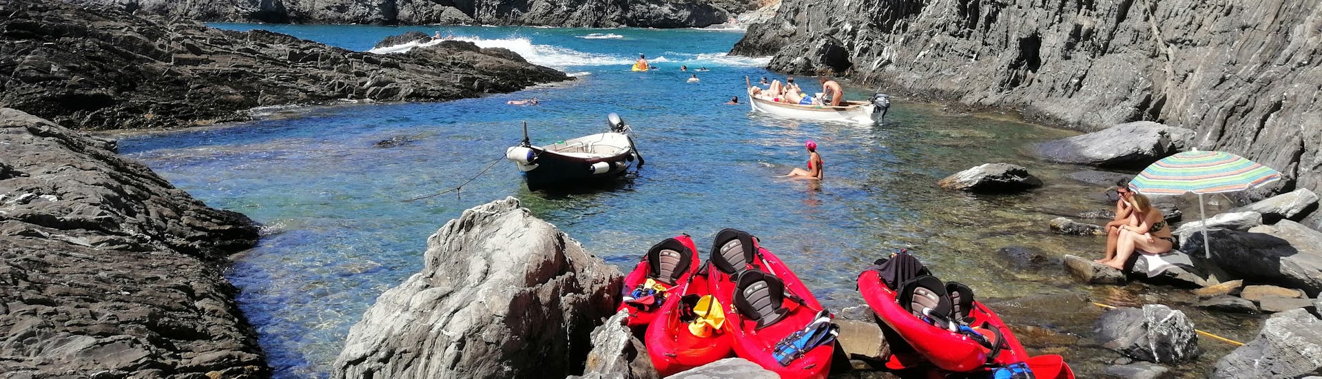 The kayaks are left on the side while everyone is exploring the rocking area during the Kayak Tour in Monterosso - Happy Hour with Carnassa Cinque Terre Kayak Tour.