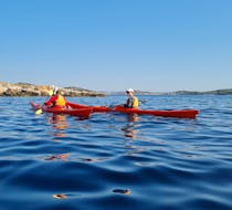 Two participants enjoying the Private Full Day Kayak Tour from Zlarin with Peak & Paddle Šibenik on the water.