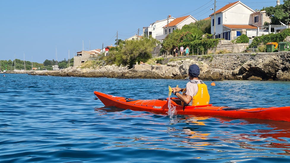 One participant of the Private Island Hopping Sea Kayak Tour from Zlarin - Full Day with Peak & Paddle Croatia Šibenik from Zlarin - Full Day in a kayak on the water.