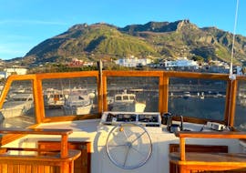 The boat from Rocca Corsa is navigating around the island of Ischia to Spiaggia di Citara.