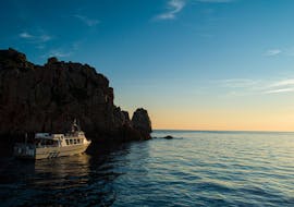 Isula Croisières boat going to the Calanques de Piana at sunset.