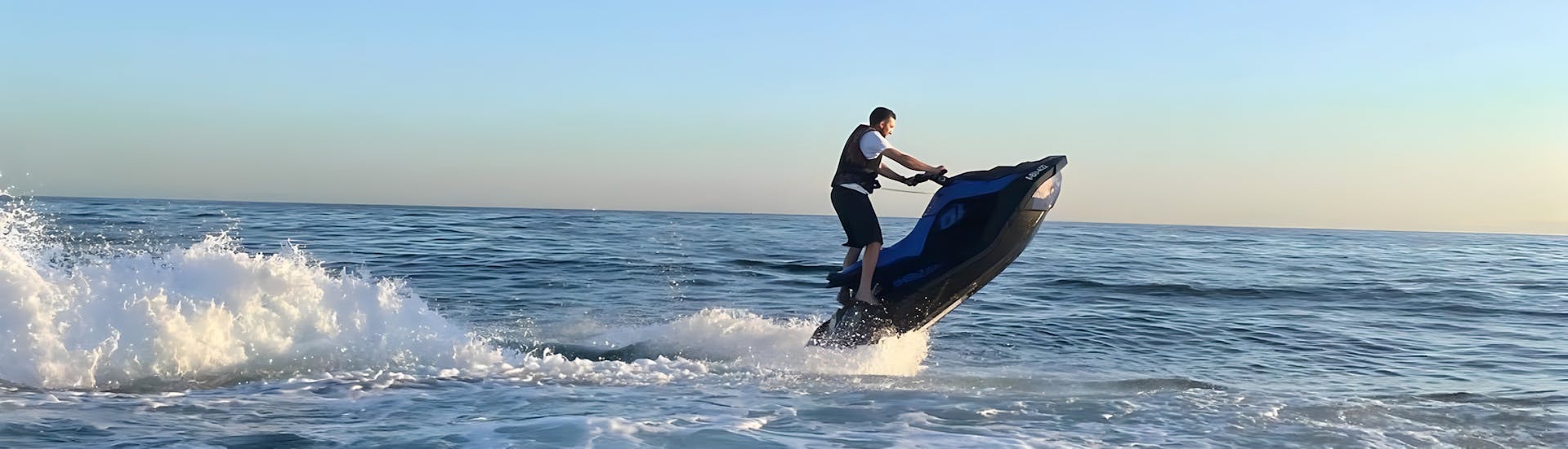 A boy speeding along on a jet ski rented from Boat2Go Marbella.