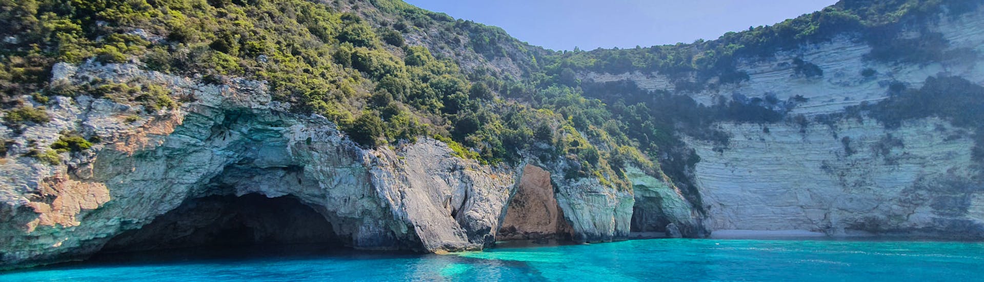 View of the Sea Caves from the boat of Kavos Cruises.