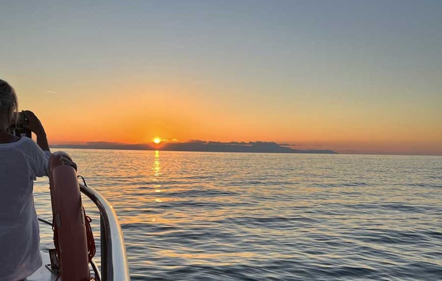 A woman enjoying the sunset on the Glass-Bottom Boat Trip to Lazaretta at Sunset.