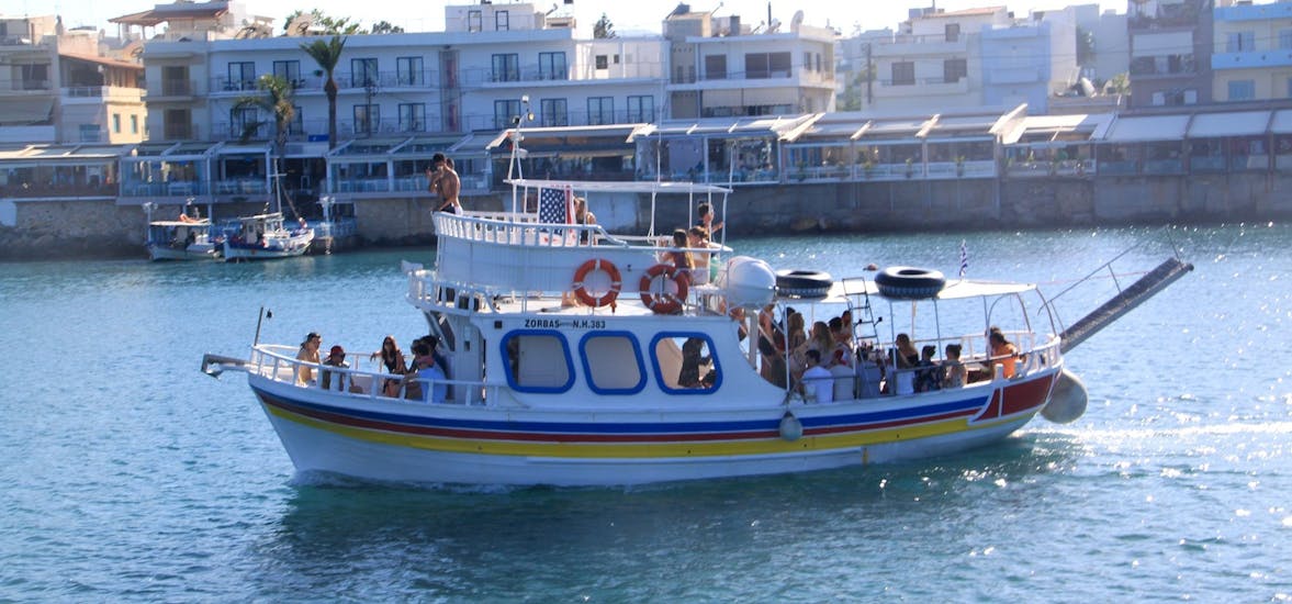 The boat is navigating with all the participants onboard during the Boat Trip along the Coastline to Saint George's Bay with Zorbas Cruises Hersonissos.