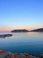The sunset viewed from the harbour during the Private Sunset Boat Trip from Elounda along the coast with Indigo Cruises Elounda.