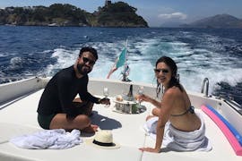 Un couple savoure quelques boissons pendant une Balade privée en bateau à la Grotte bleue & Capri avec Snorkeling avec Giuliani Charter Sorrento.
