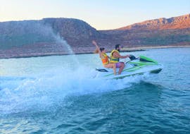 Two jet ski's in the blue cretan waters with 2 people sitting on each jet ski during Jet Ski Rental in Kissamos by Kissamos Sea Sports.