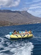 Inflatable Crazy Sofa getting towed by a speedboat during Crazy Sofa in Kissamos by Kissamos Sea Sports.