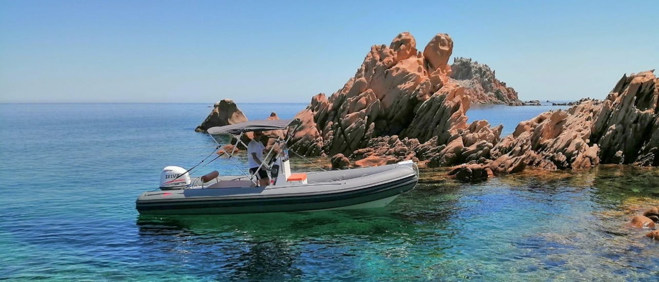 Rocce Rosse's RIB boat viewed from the coast during the RIB Boat Rental in Arbatax (up to 6 people) with Rocce Rosse.